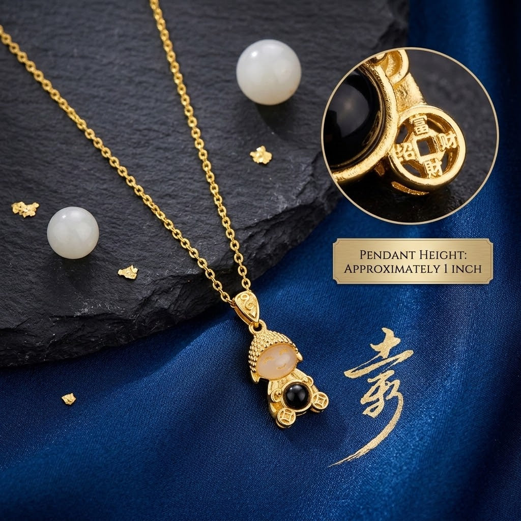 Gold doll pendant necklace with cream face, black bead, and engraved top charm