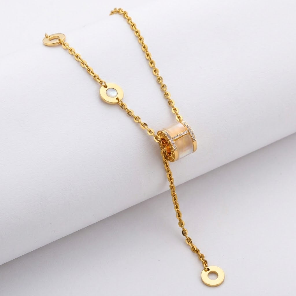 Gold-tone triple ring crystal charm necklace with crystal ring centerpiece detail