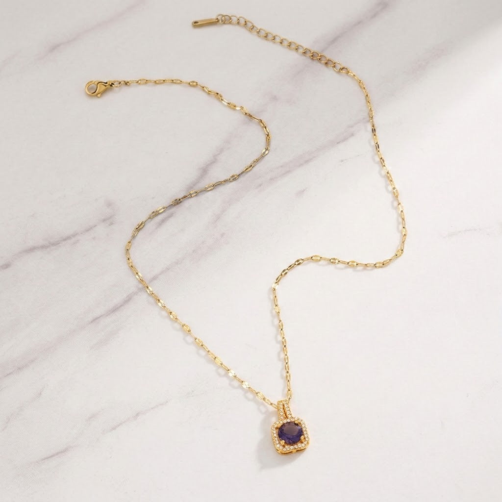 Gold pendant necklace with blue cushion halo gemstone and extender chain