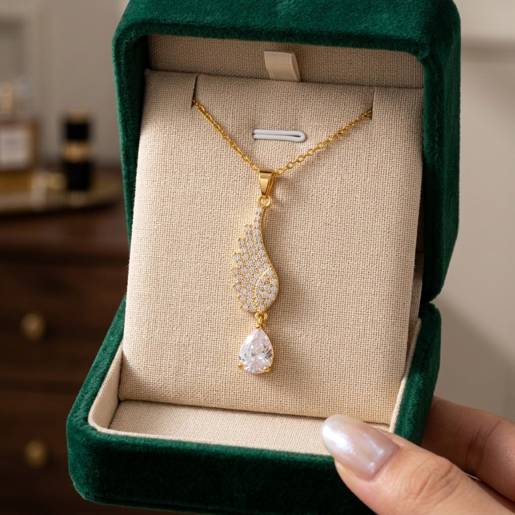Gold-tone wing teardrop charm necklace with clear crystal pendant