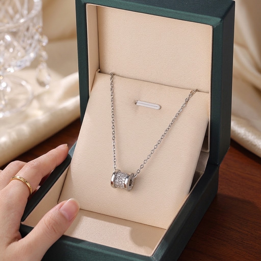 Silver cylindrical pendant necklace with pave-look cylinder charm on link chain, gift box view.