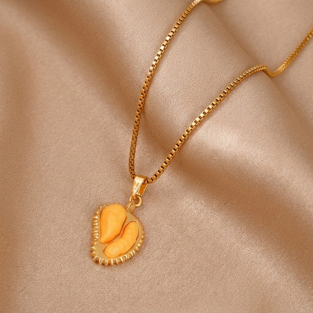 Gold-tone pendant necklace with open durian pod charm, heart-shaped resin