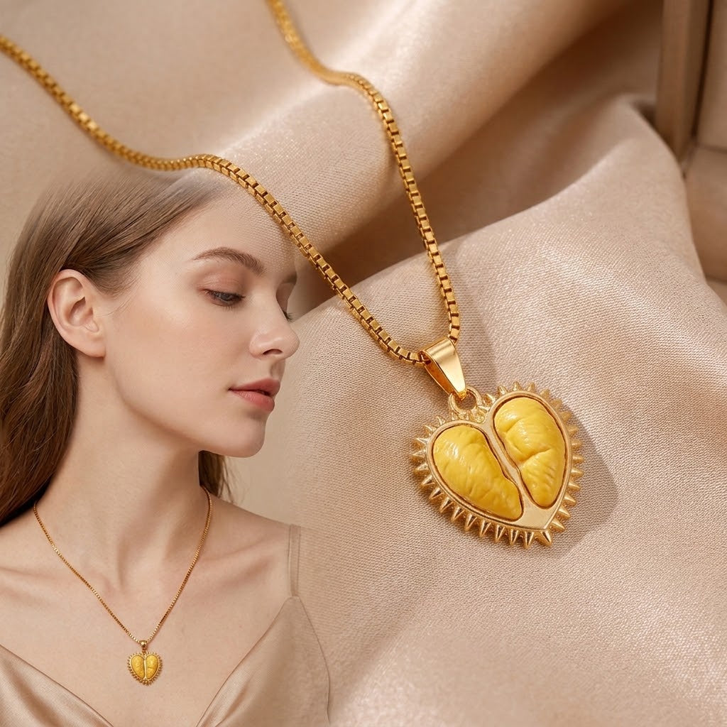 Gold-tone pendant necklace worn on model, open durian pod charm with resin segments
