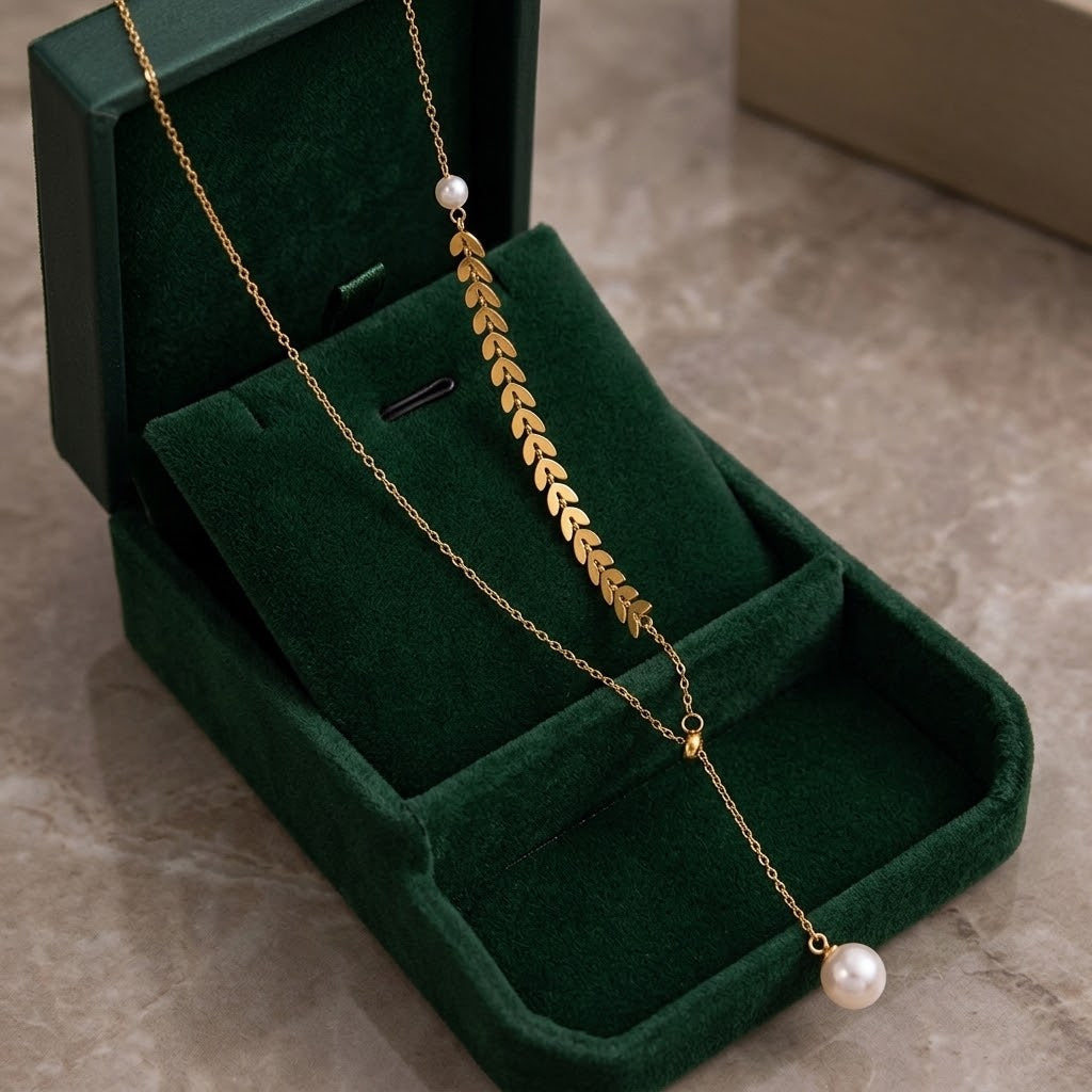 Gold leaf cluster charm necklace with pearl end bead and fine chain