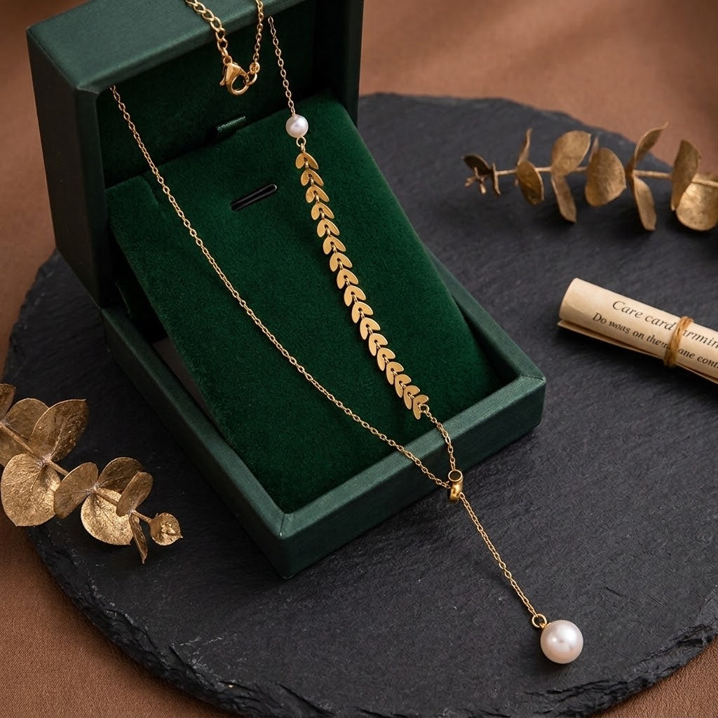 Gold leaf cluster charm necklace with pearl drop bead on a fine chain