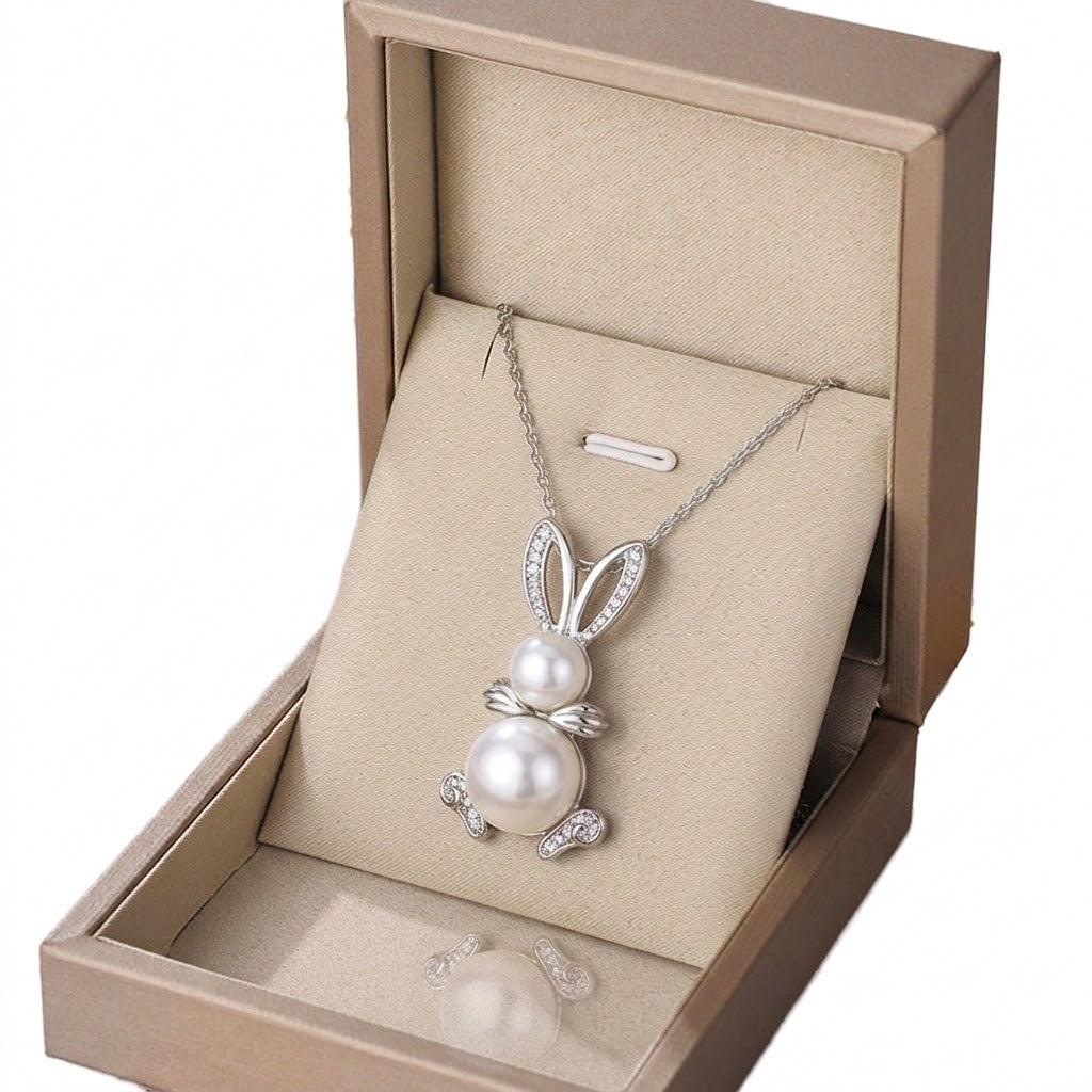 Silver-tone peanut-shaped charm necklace with dangling white pearl and crystal detailing