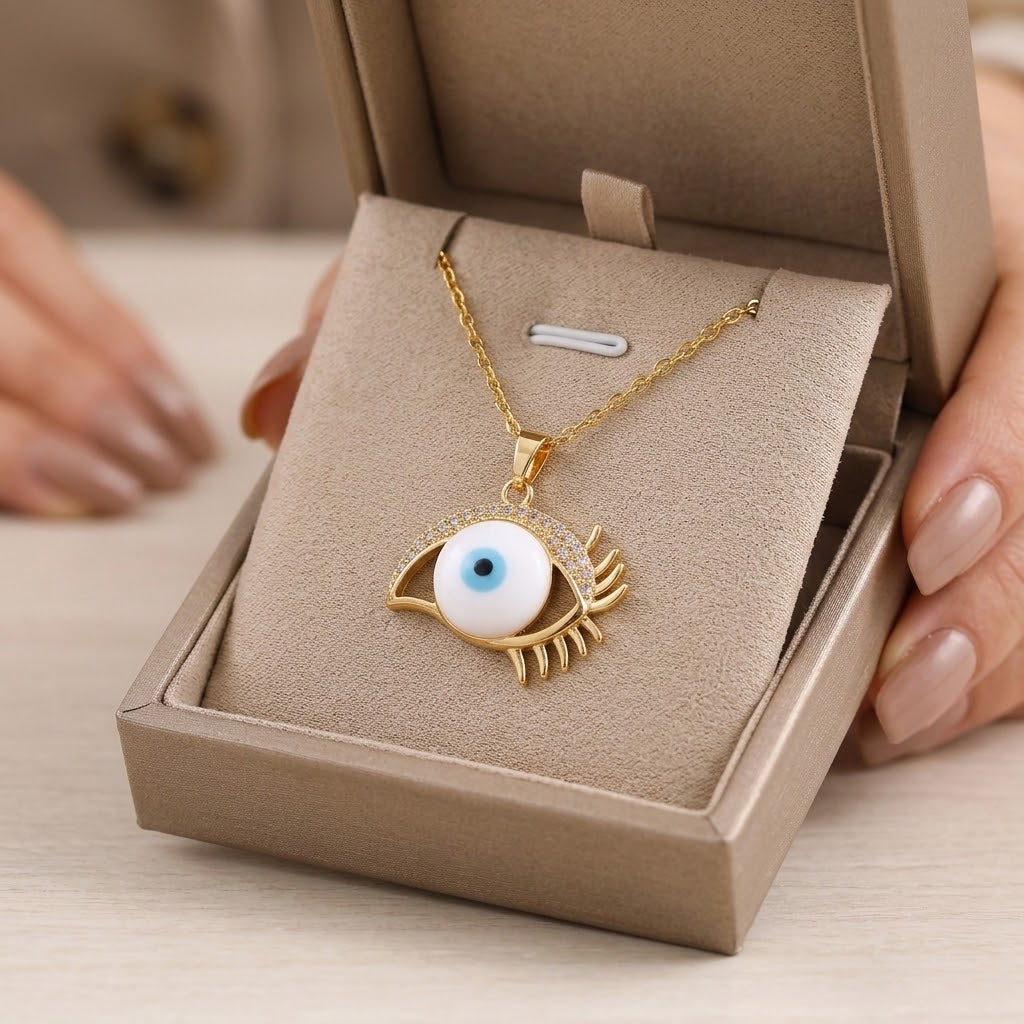 Eye-shaped blue enamel pendant on gold-tone chain in a beige gift box
