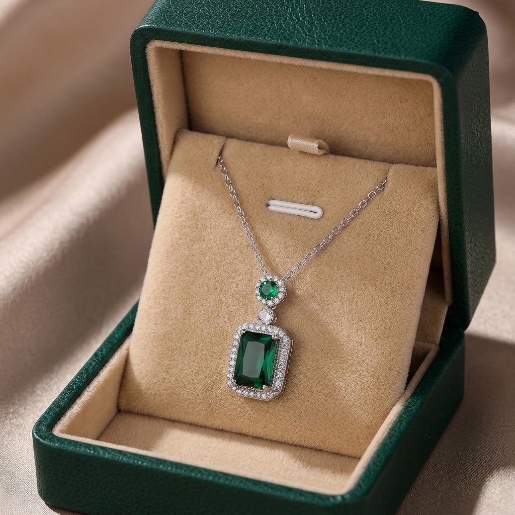 Silver-tone gemstone charm necklace with green square pendant and halo accents