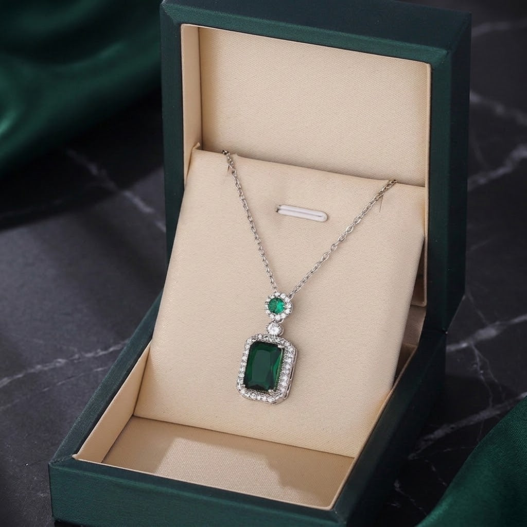 Silver-tone gemstone charm necklace with green square pendant, presented in green gift box