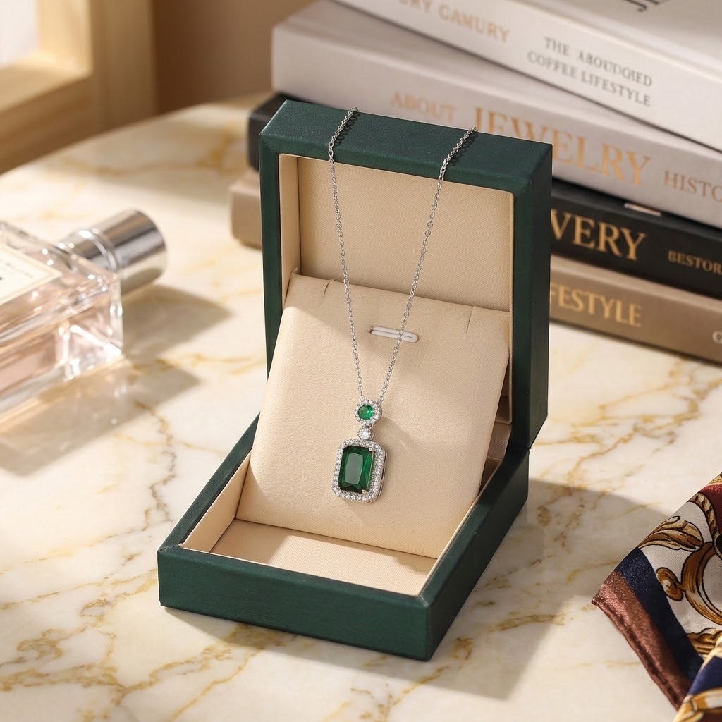 Silver-tone gemstone charm necklace with green square pendant on chain, in green box