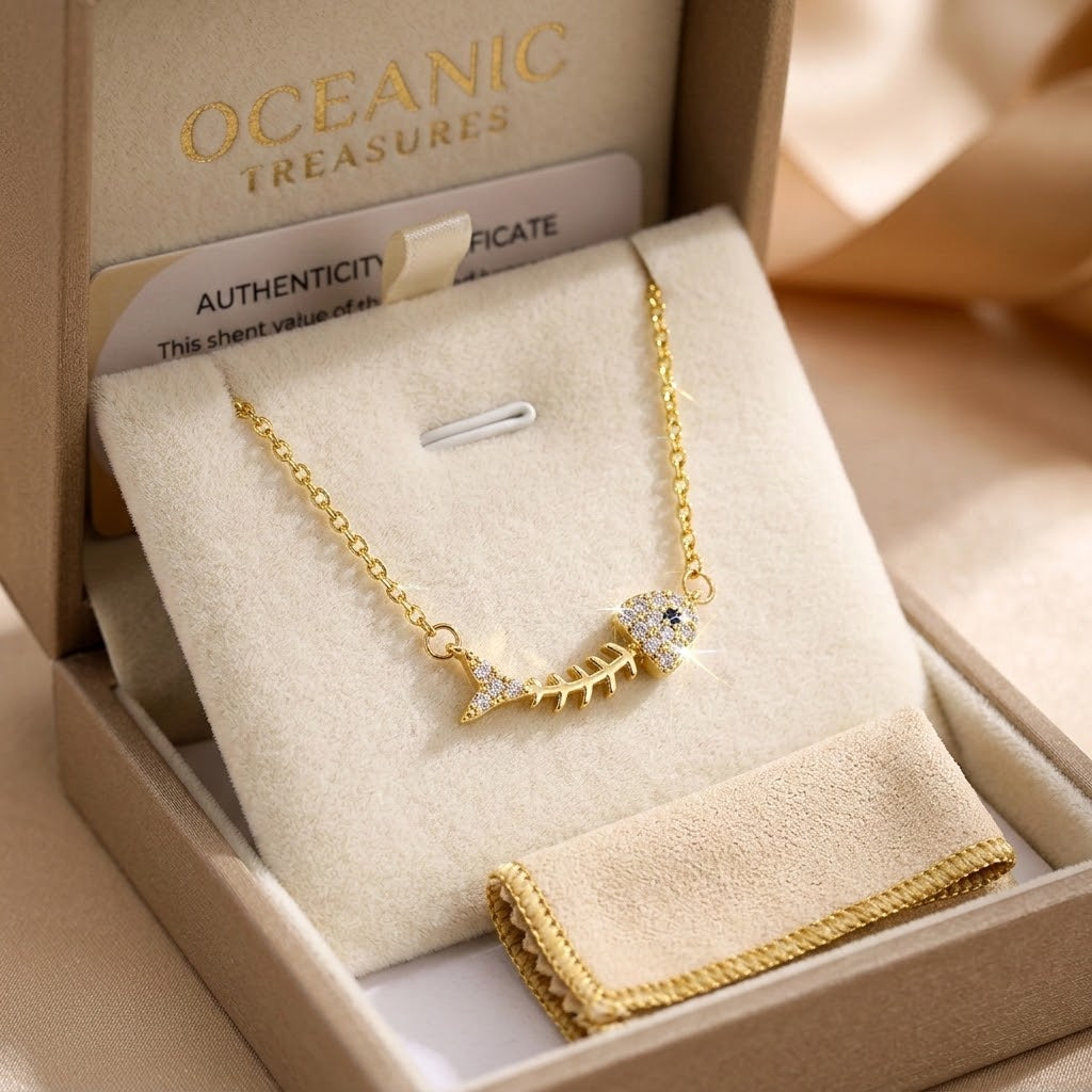 Gold-tone fishbone charm necklace with round crystal centerpiece in gift box