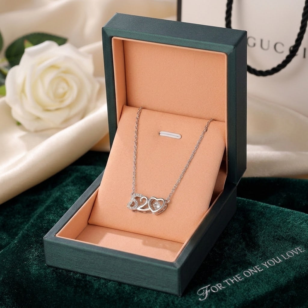 Silver-tone '520' heart pendant necklace displayed in a box
