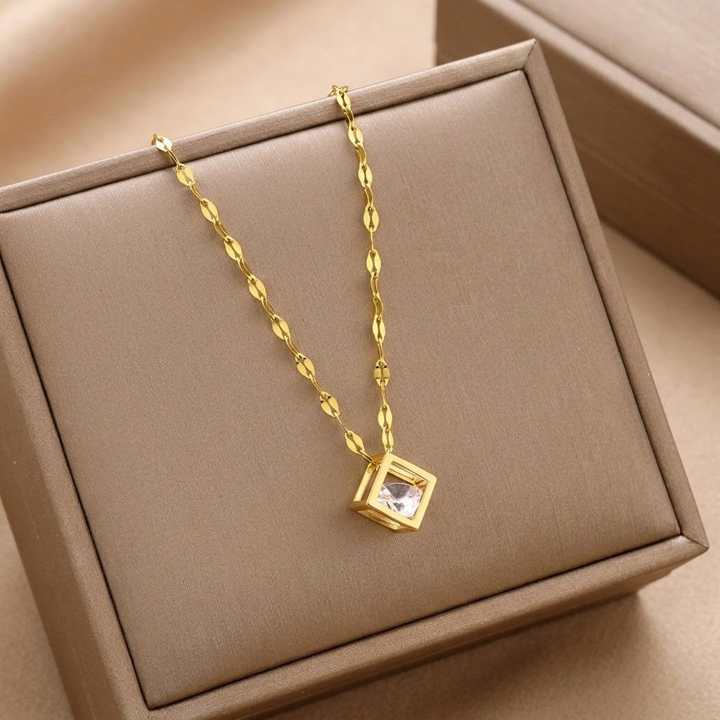 Gold square charm necklace with clear cubic pendant on textured flat link chain