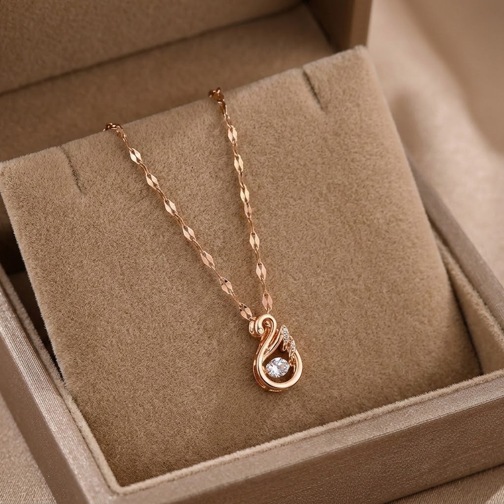Rose gold swan charm necklace with sparkling stone drop pendant on textured link chain