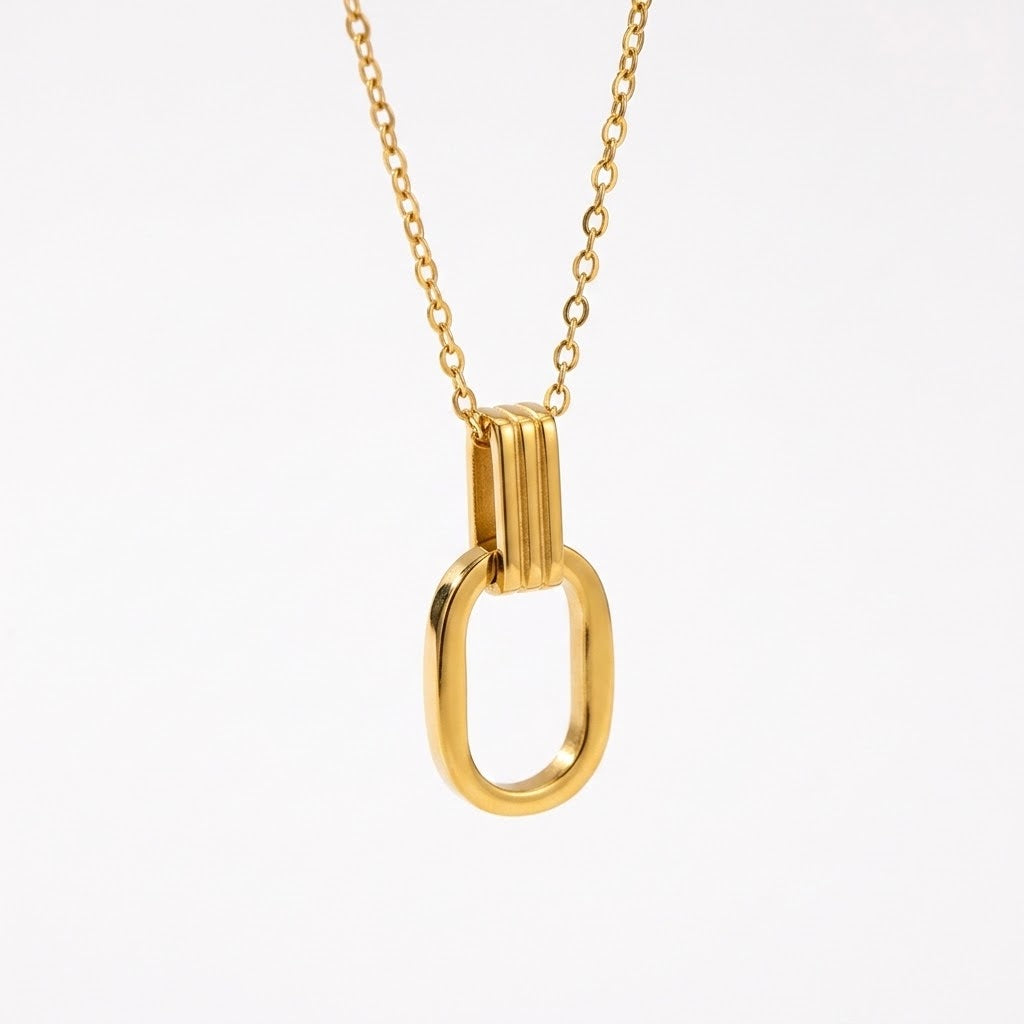 Gold O-shaped charm necklace with open oval pendant and short vertical bar detail