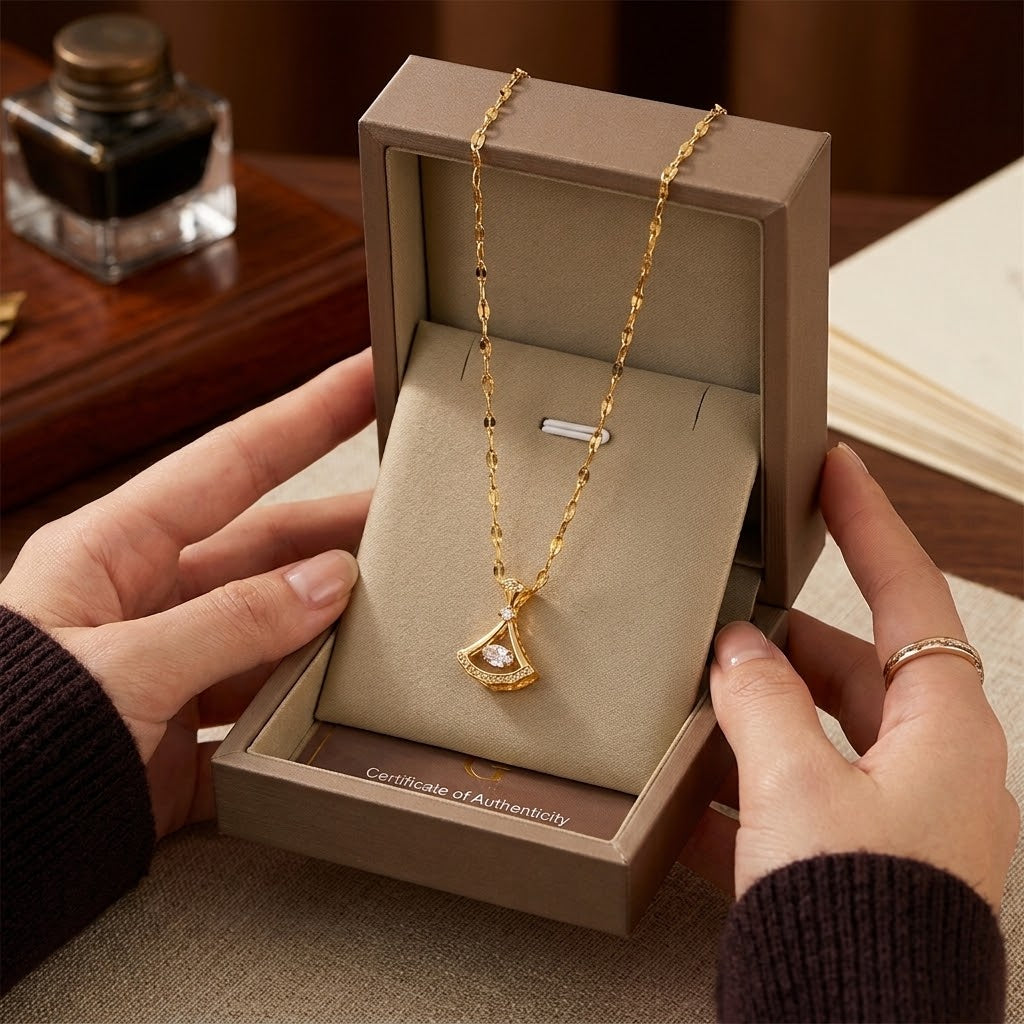 Gold-tone petal pendant necklace with teardrop charm and clear stone sparkle.