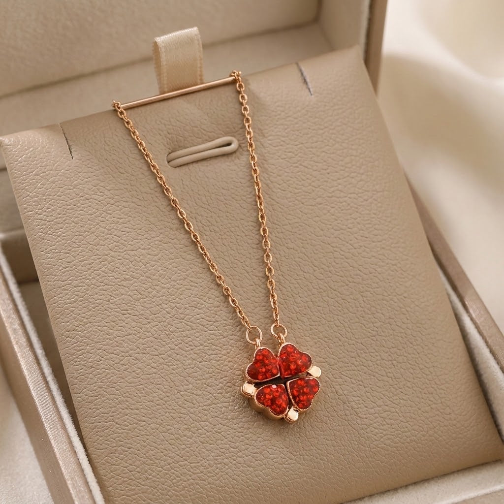 Rose-gold tone necklace with red heart flower pendant on beige jewelry tray