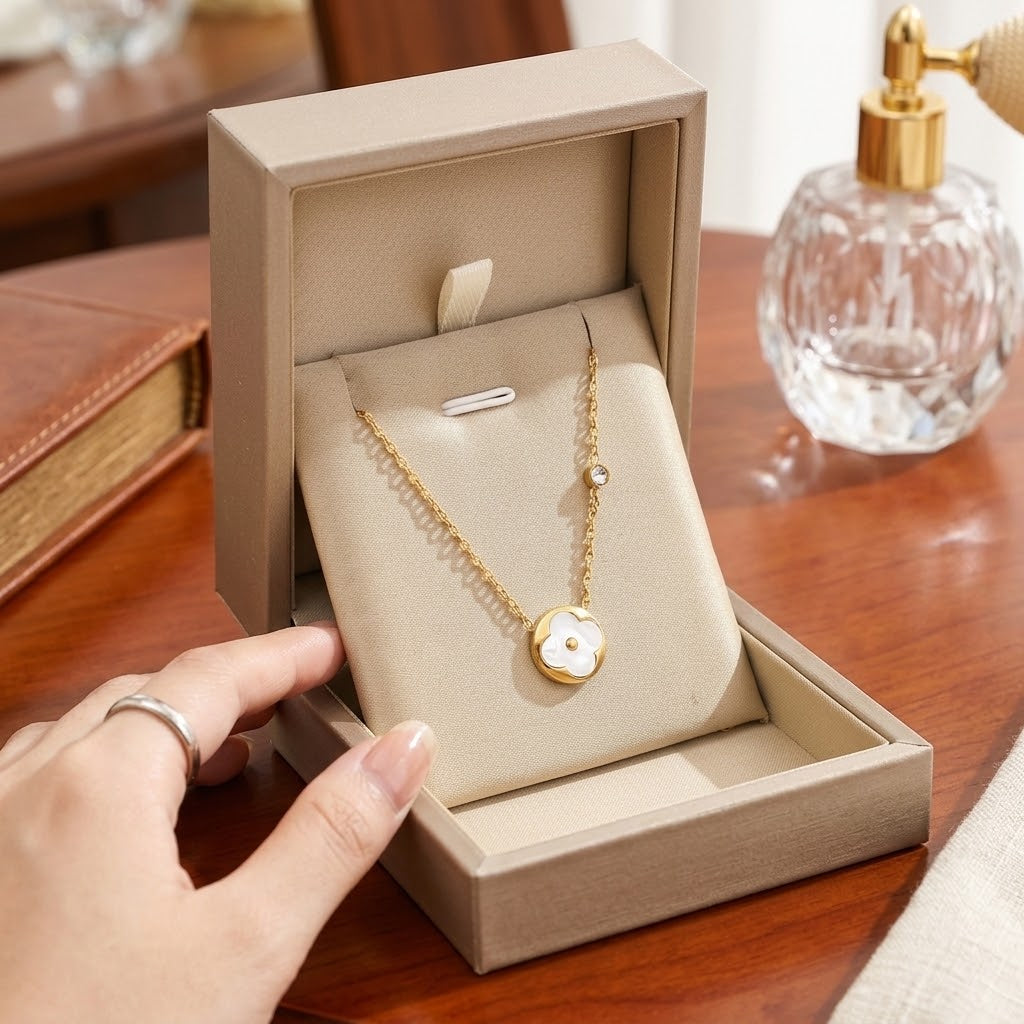 Gold-tone flower petal pendant necklace with round white inlay on fine chain