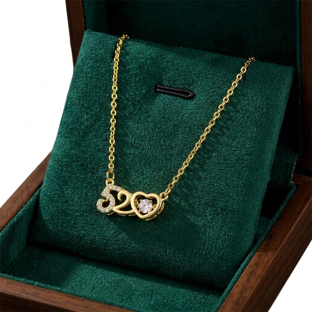 Gold-tone heart charm necklace with '520' pendant and round crystal accents