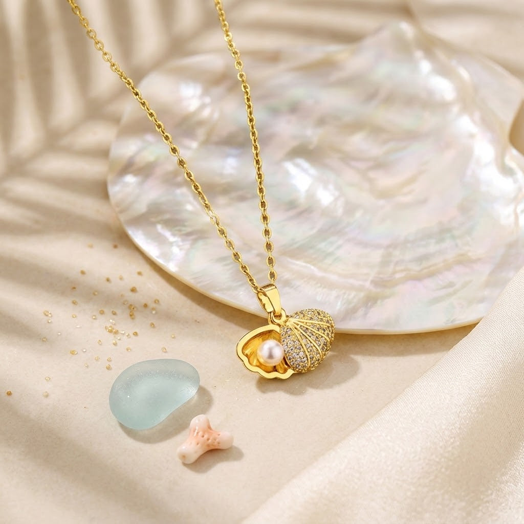Gold shell pendant necklace with round pearl and rhinestone-studded seashell cap