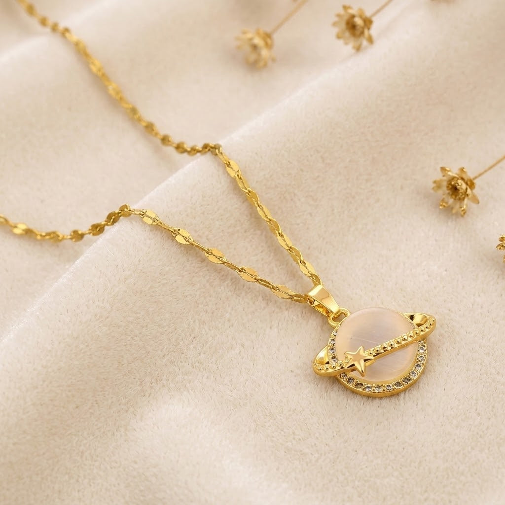 Gold-tone star globe charm necklace with crescent moon pendant and rhinestone trim