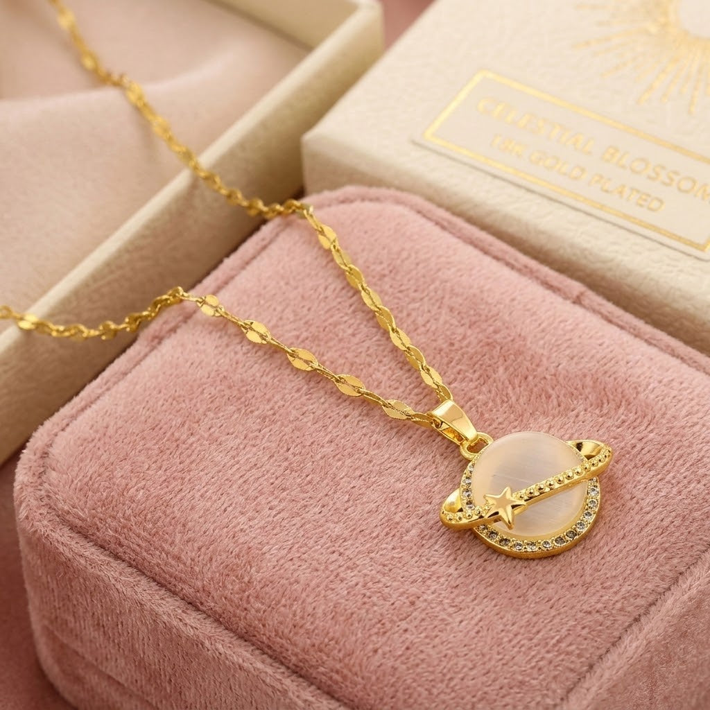 Gold-tone charm necklace featuring crescent moon globe pendant with star and rhinestone border