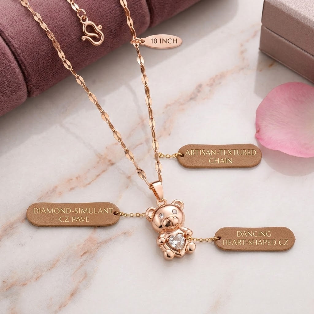 Rose-gold teddy bear charm necklace with heart-shaped crystal pendant on link chain