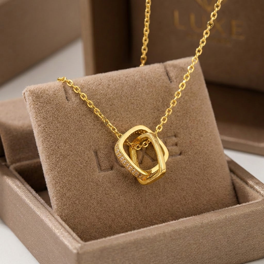 Gold-tone double square charm necklace with oval link pendant and sparkle stones