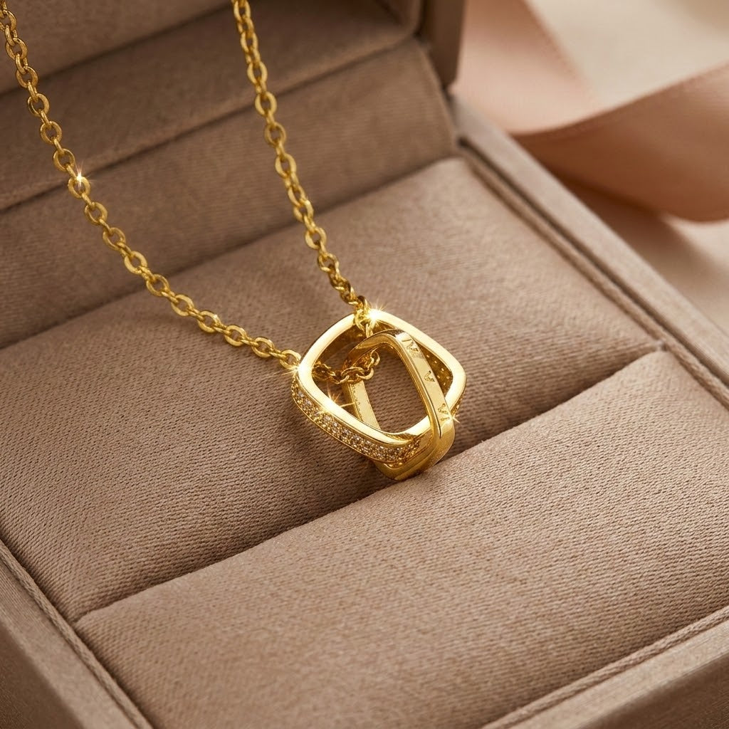 Gold-tone square ring charm necklace with small crystal-set bezel pendant