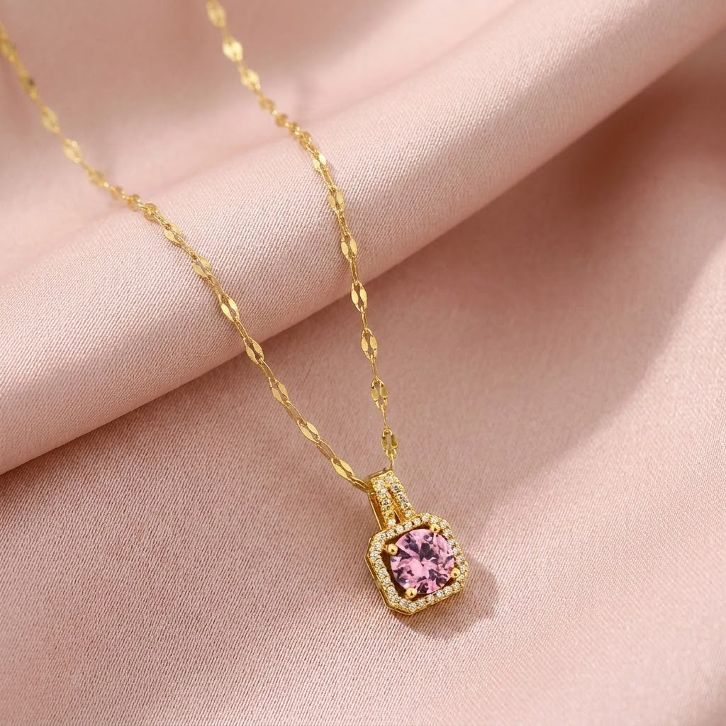 Gold pendant necklace with pink cushion gemstone in halo frame