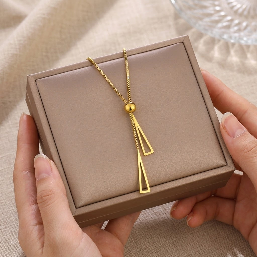 Gold double triangle charm necklace on gift box, two dangling triangle charms