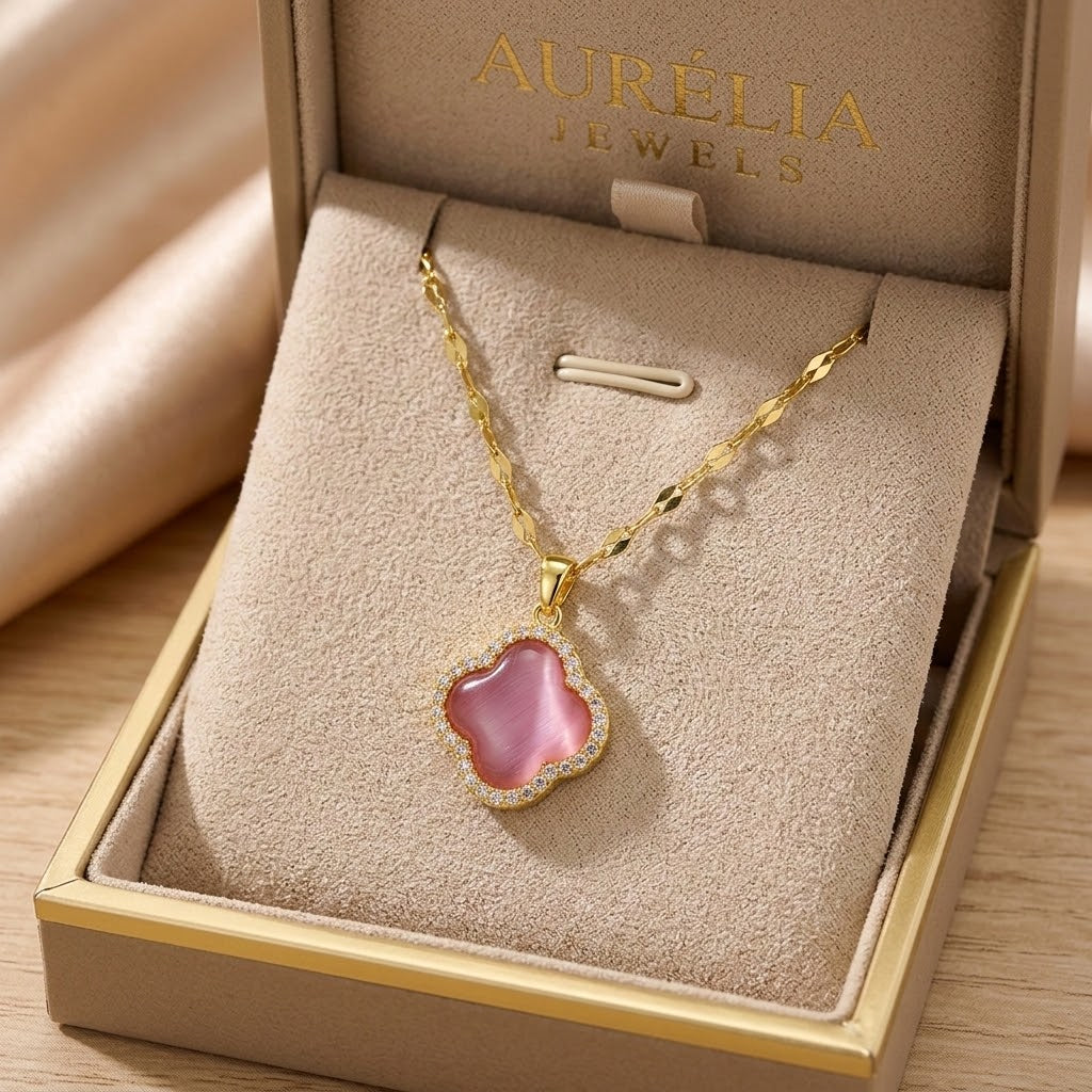Gold clover pendant necklace with pink enamel center and glittering halo edge