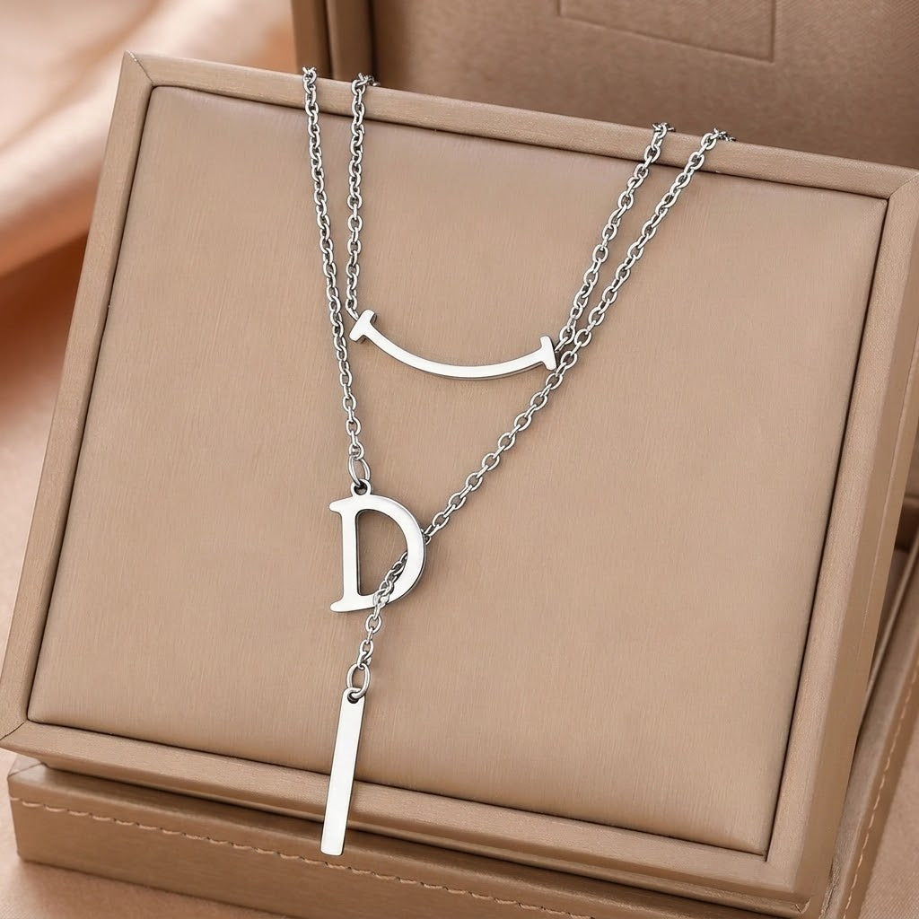 Silver letter D charm necklace with curved smile charm and long bar pendant
