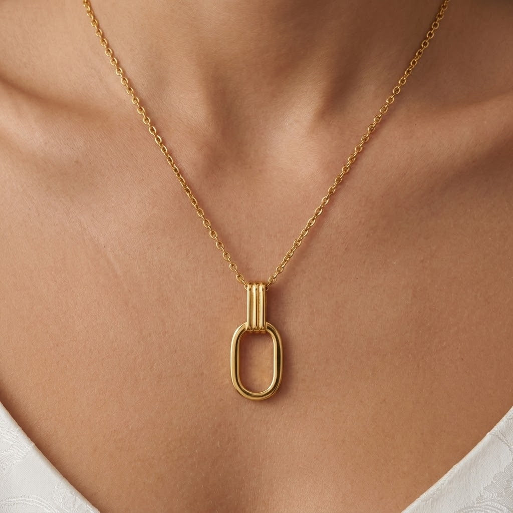Gold O-shaped charm necklace shown on neck with open oval pendant