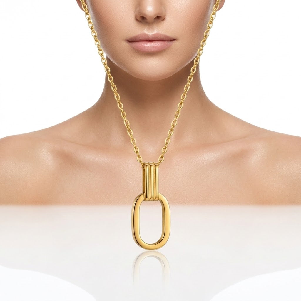 Gold O-shaped charm necklace worn with open oval pendant centered on chest