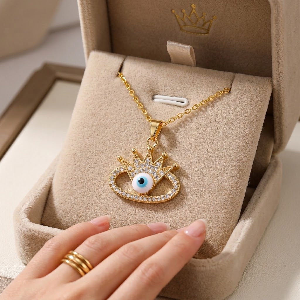 Gold eye charm pendant necklace with crown, set in a beaded frame