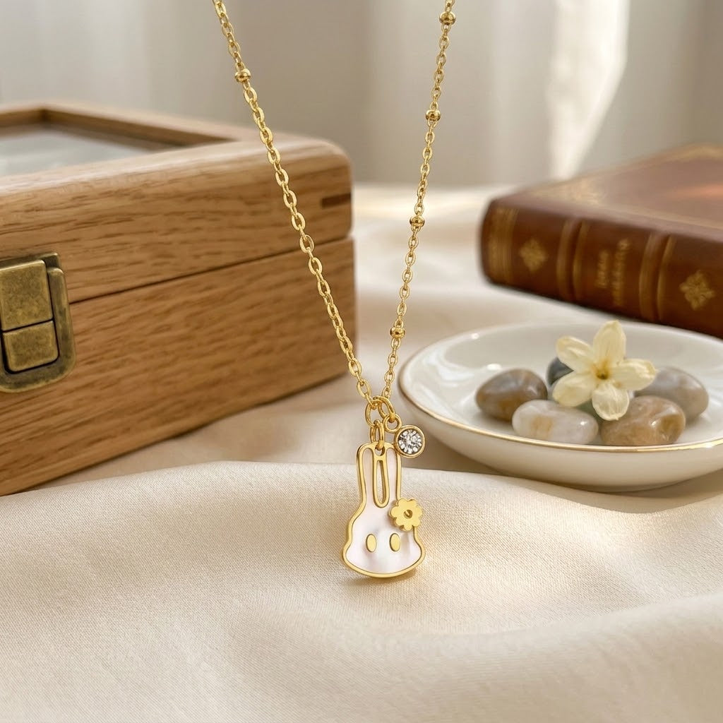 Gold-tone chain necklace with bunny-shaped pendant and small sparkle stones
