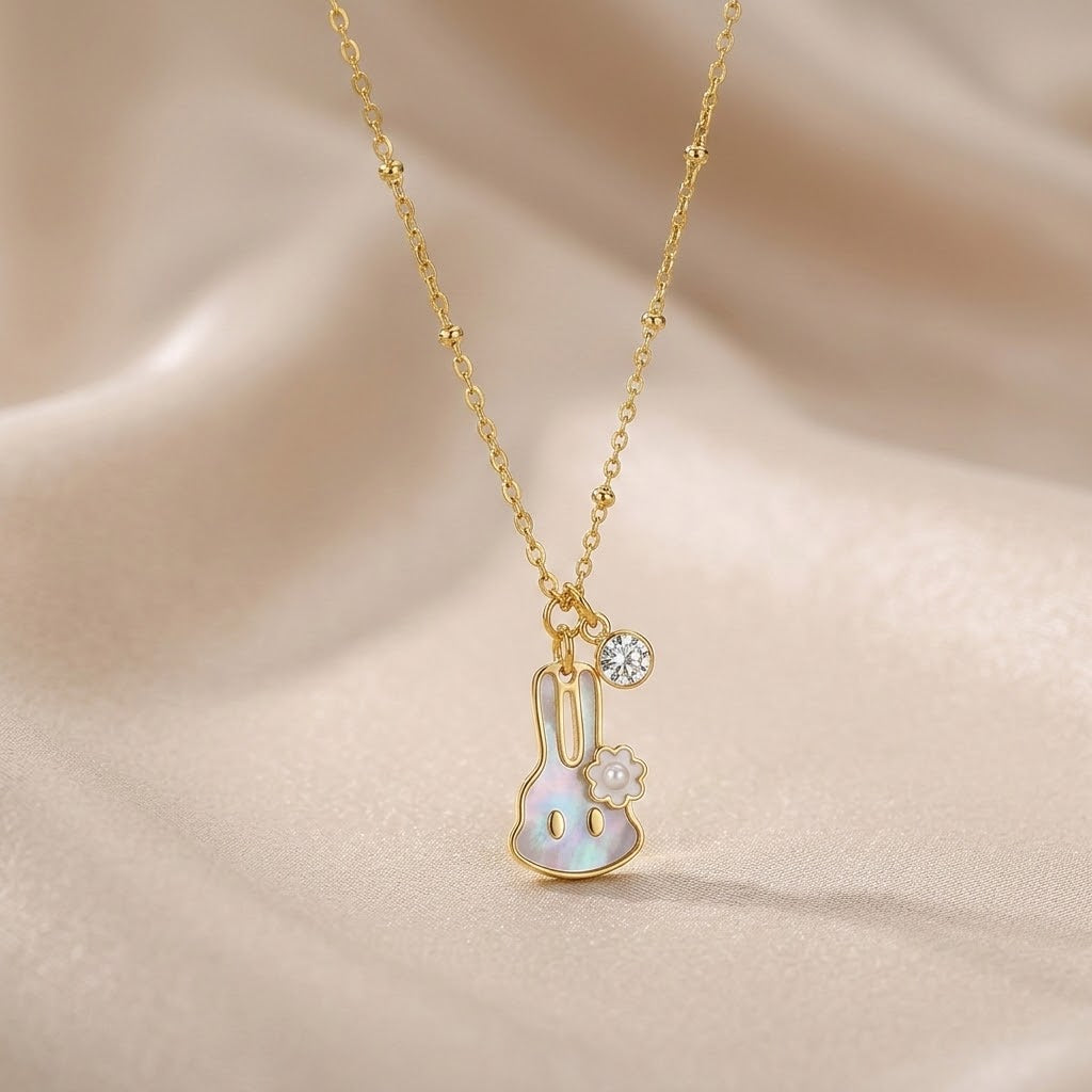 Gold-tone bunny pendant necklace with flower accent and small round sparkle