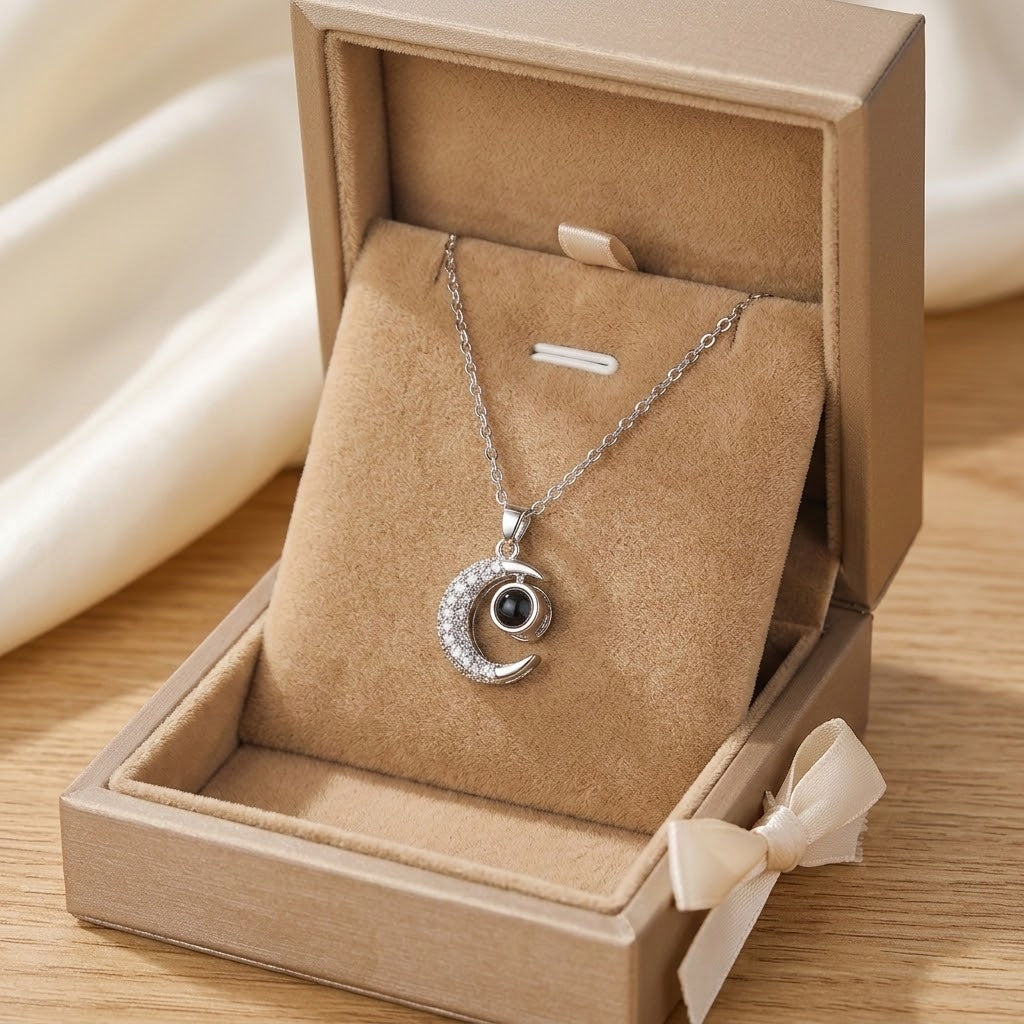 Silver crescent moon pendant necklace displayed in an open jewelry box