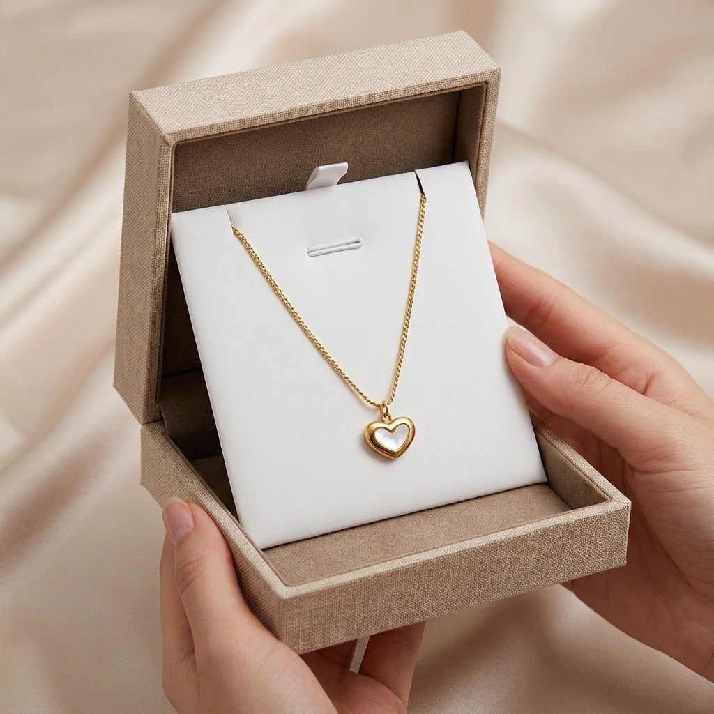 Gold-tone heart charm necklace in a gift box with small heart pendant