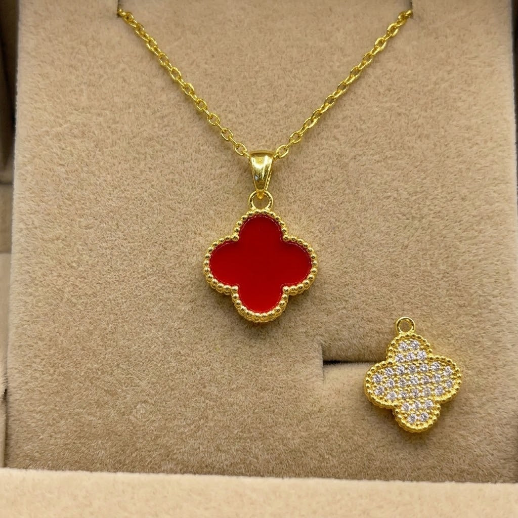 Gold chain necklace with red clover pendant and matching pavé clover charm