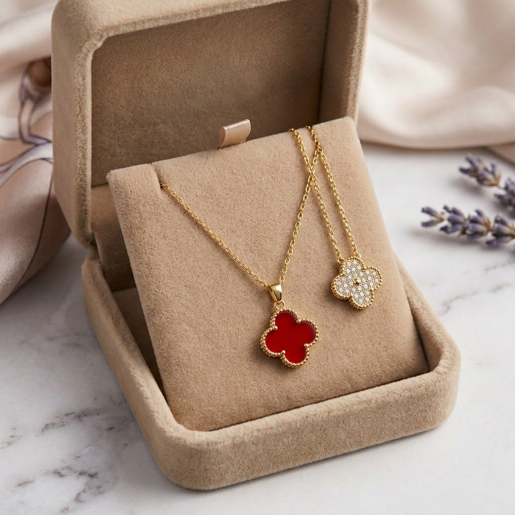 Floral pendant necklaces in velvet box, one red and one pavé flower